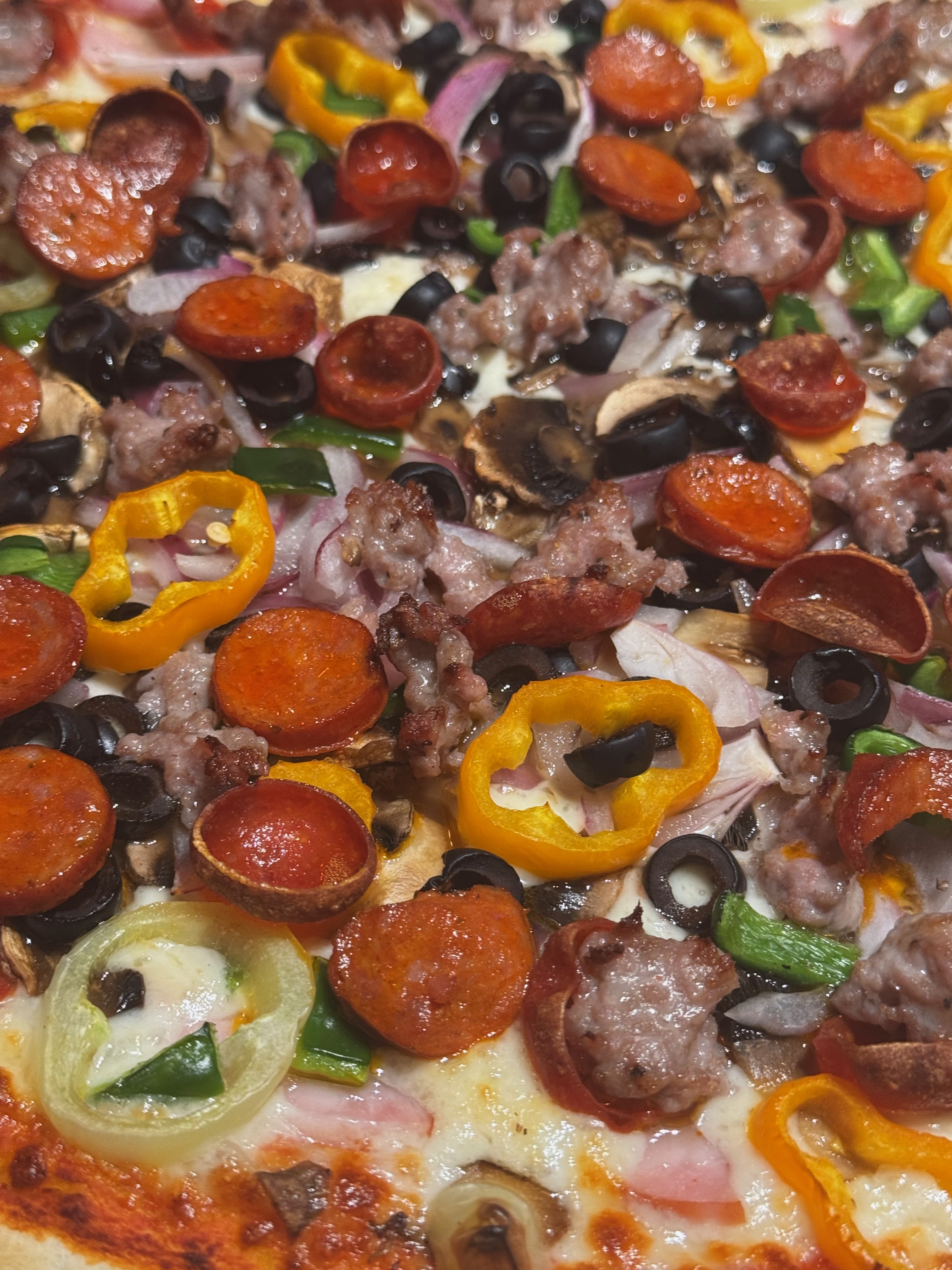 A Classic Combo pizza topped with pepperoni, sausage, mushrooms, olives, onion, peppers